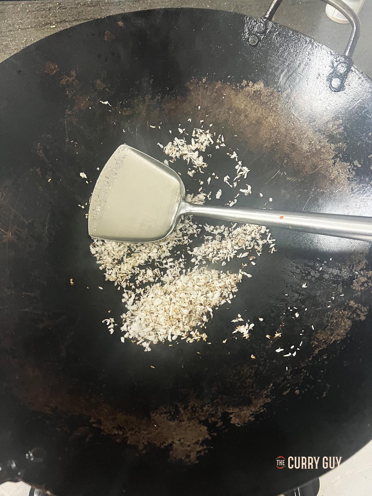 Toasting the grated coconut.