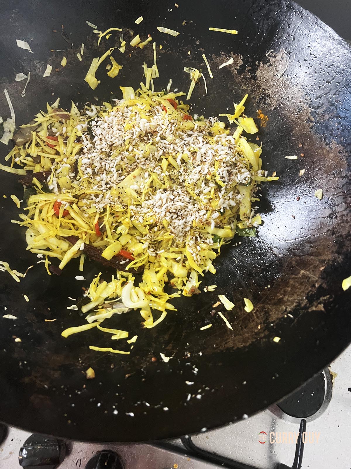 Stirring the spices together and adding the toasted coconut.