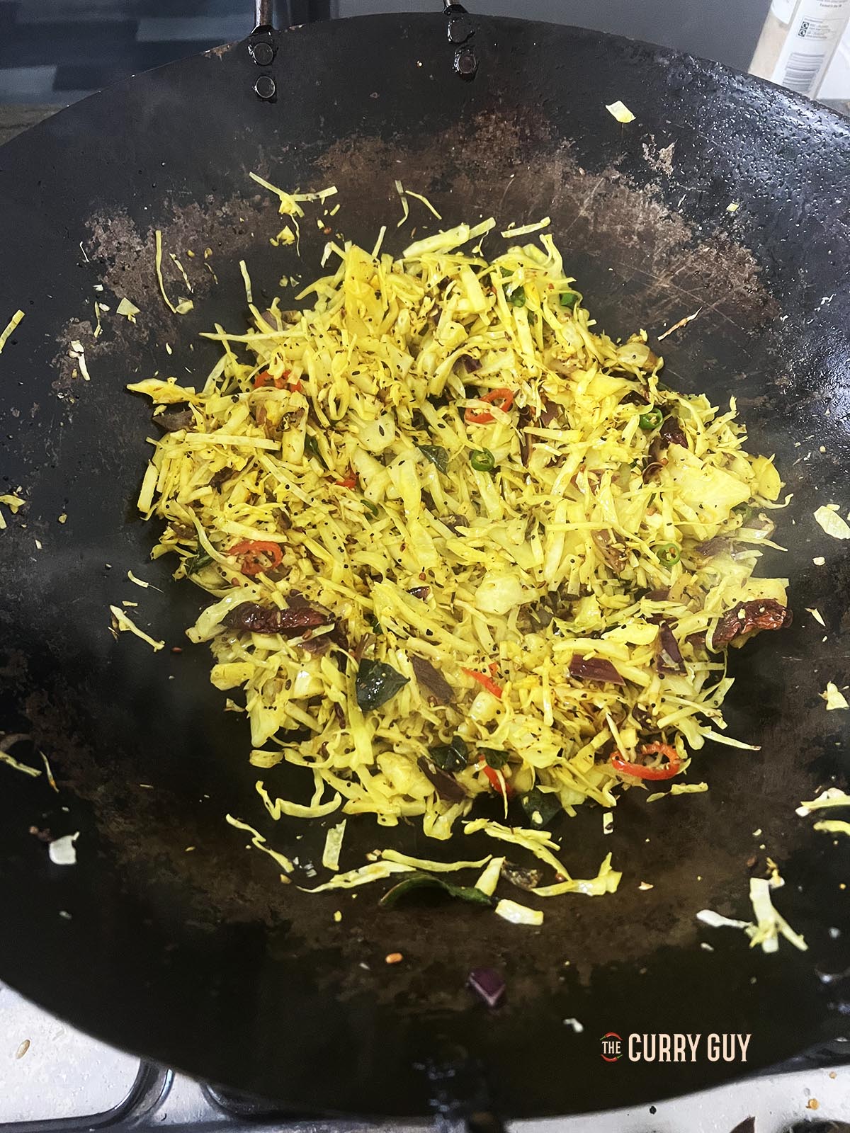 The finished cabbage thoran. Seasoning with salt and pepper. 