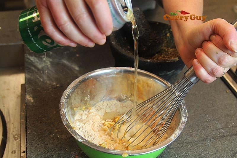 pouring beer into dry ingredients