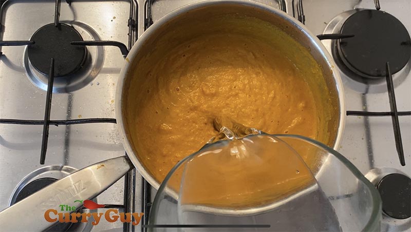 Finishing the base gravy by adding water