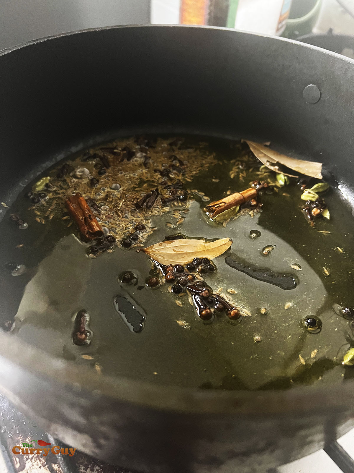 Infusing the whole spices in the ghee.