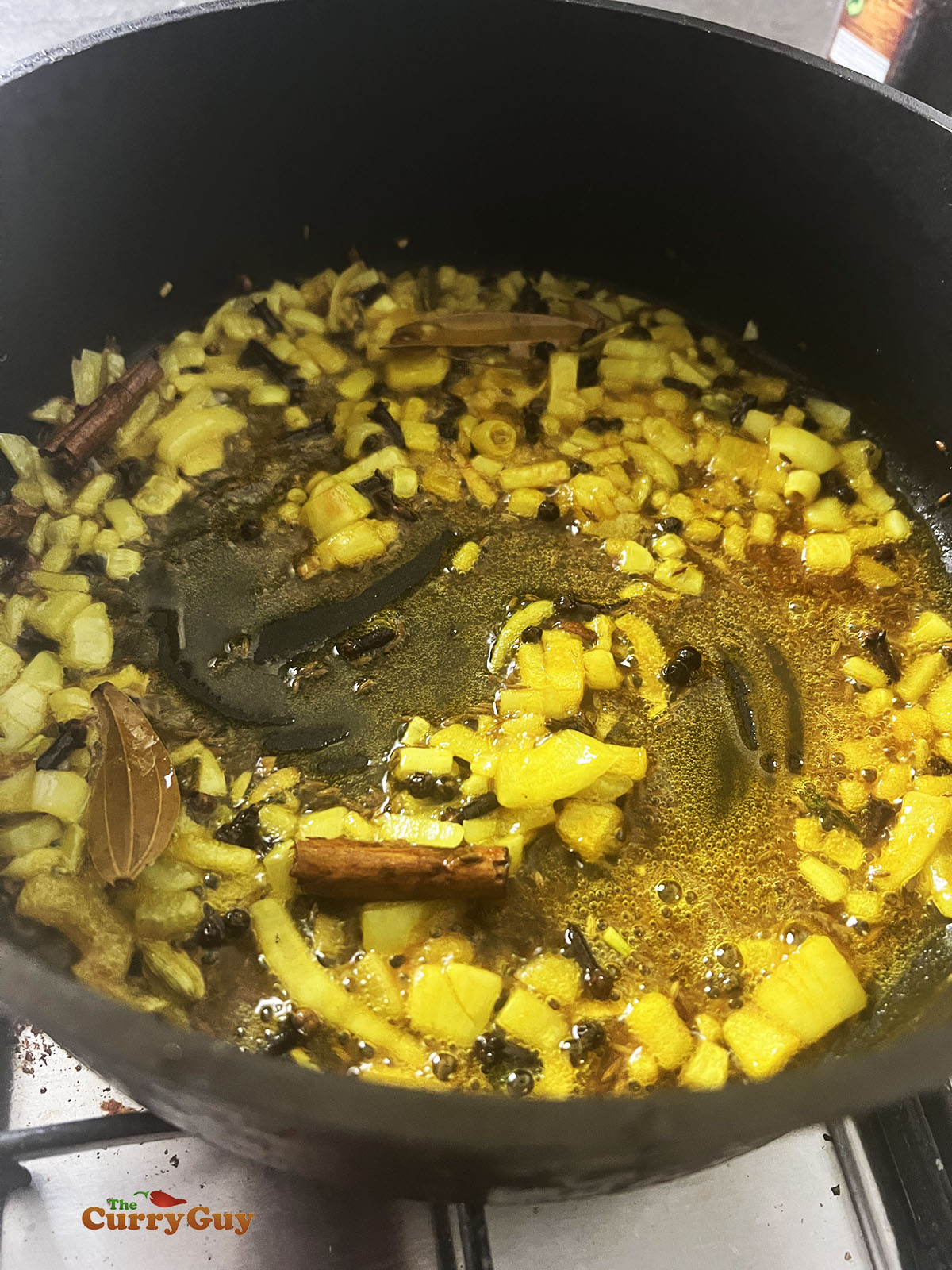 Adding turmeric to the pan.