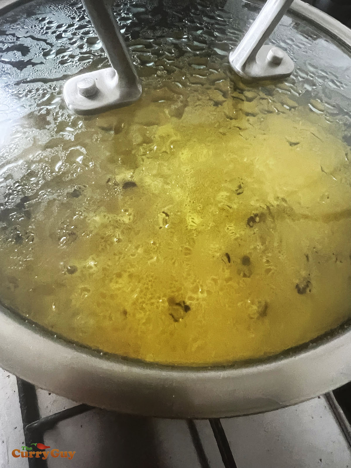Cooking the rice in a covered pan.