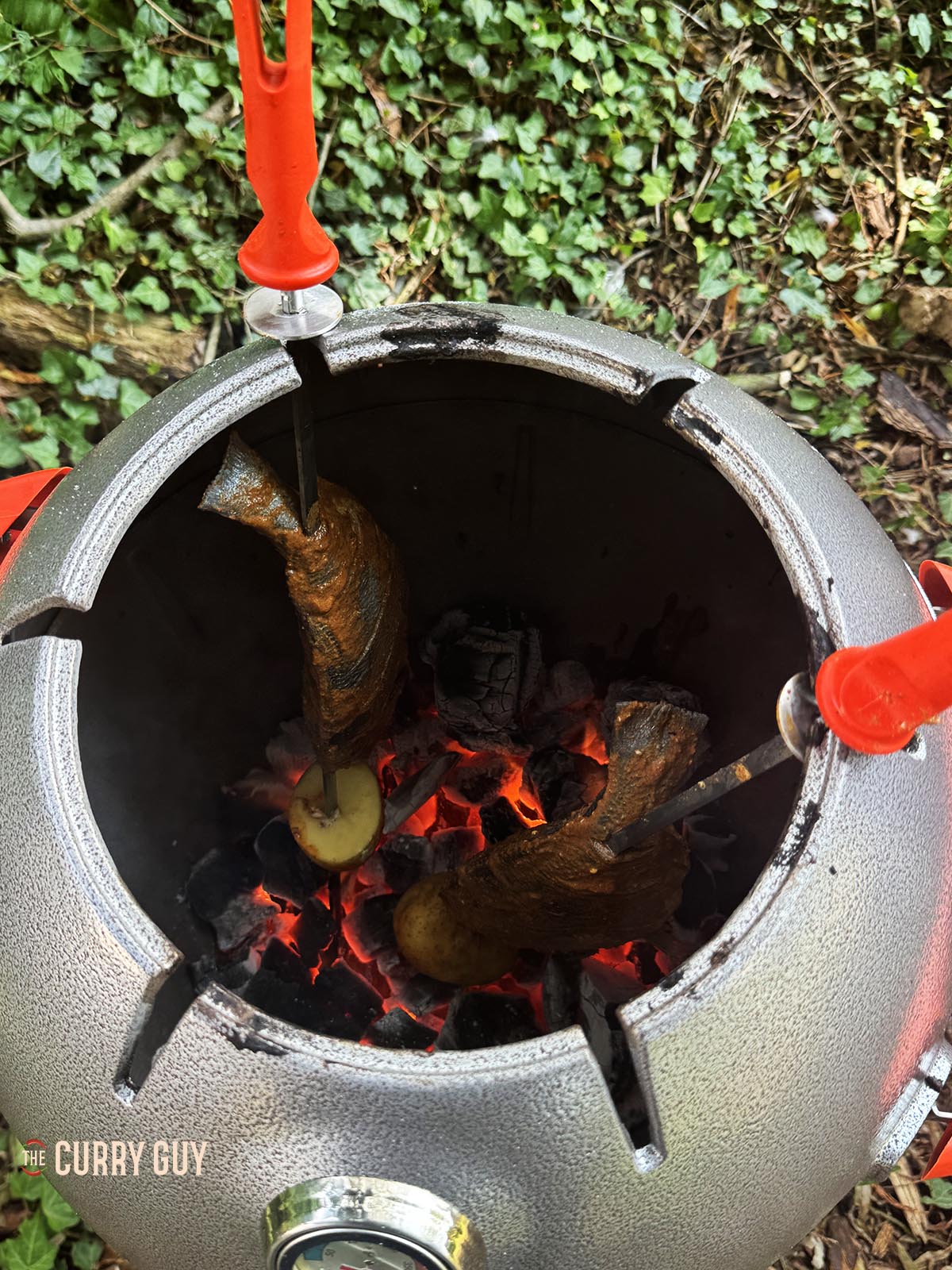 Cooking the fish in a tandoor oven.