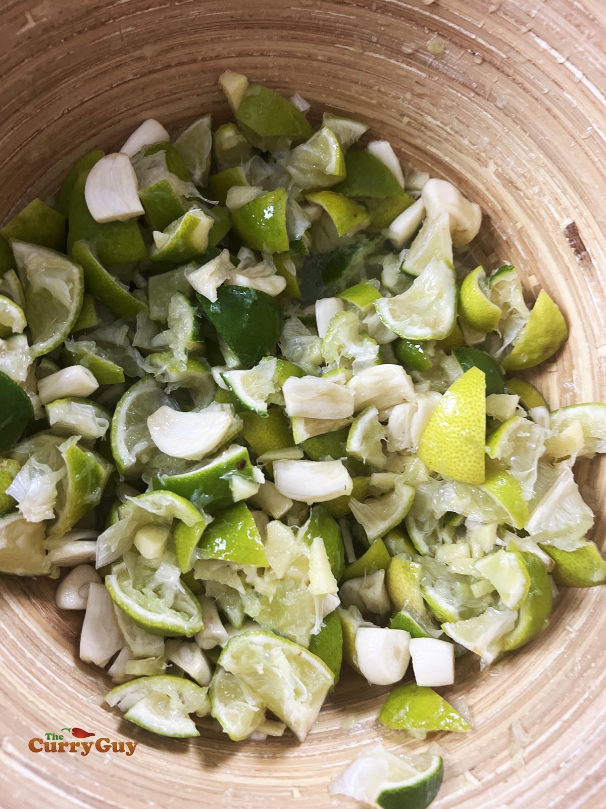 Adding chopped garlic to the mixing bowl.