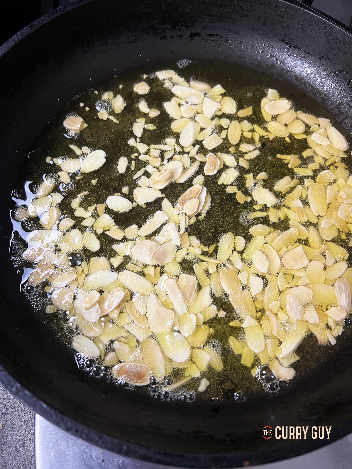 Frying the almonds in ghee.