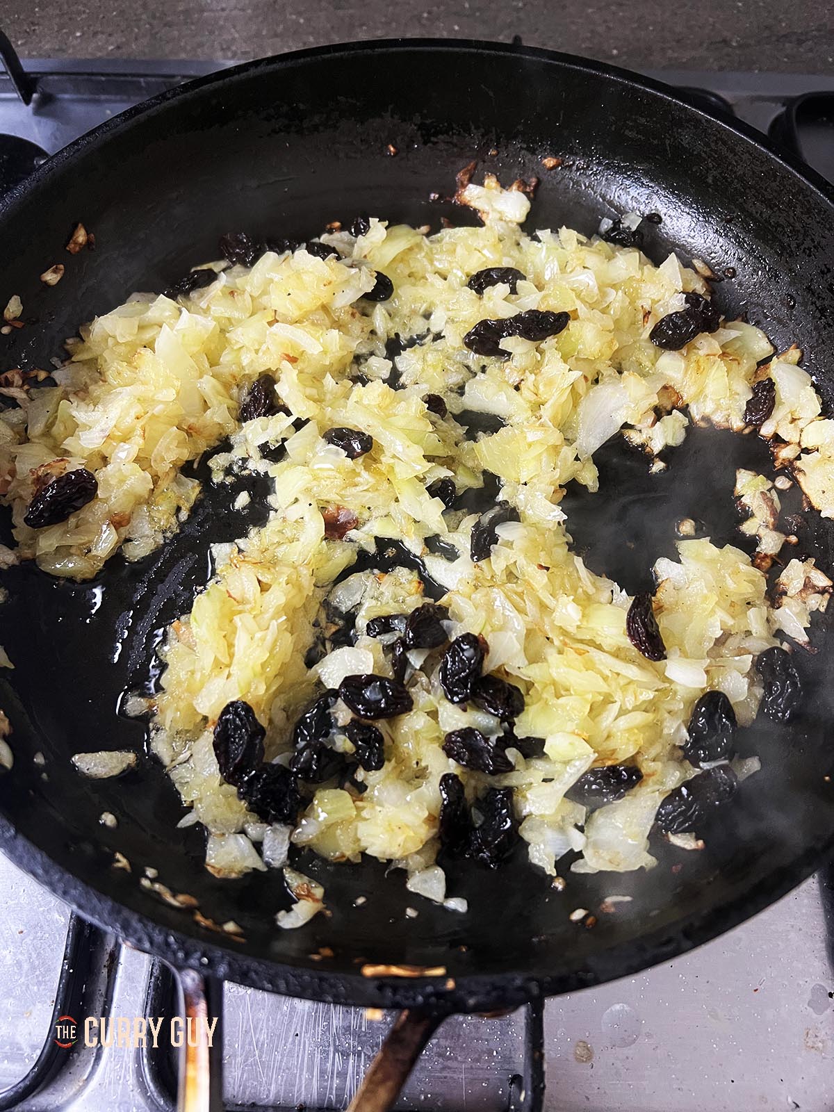 Frying the almond flakes and raisins.