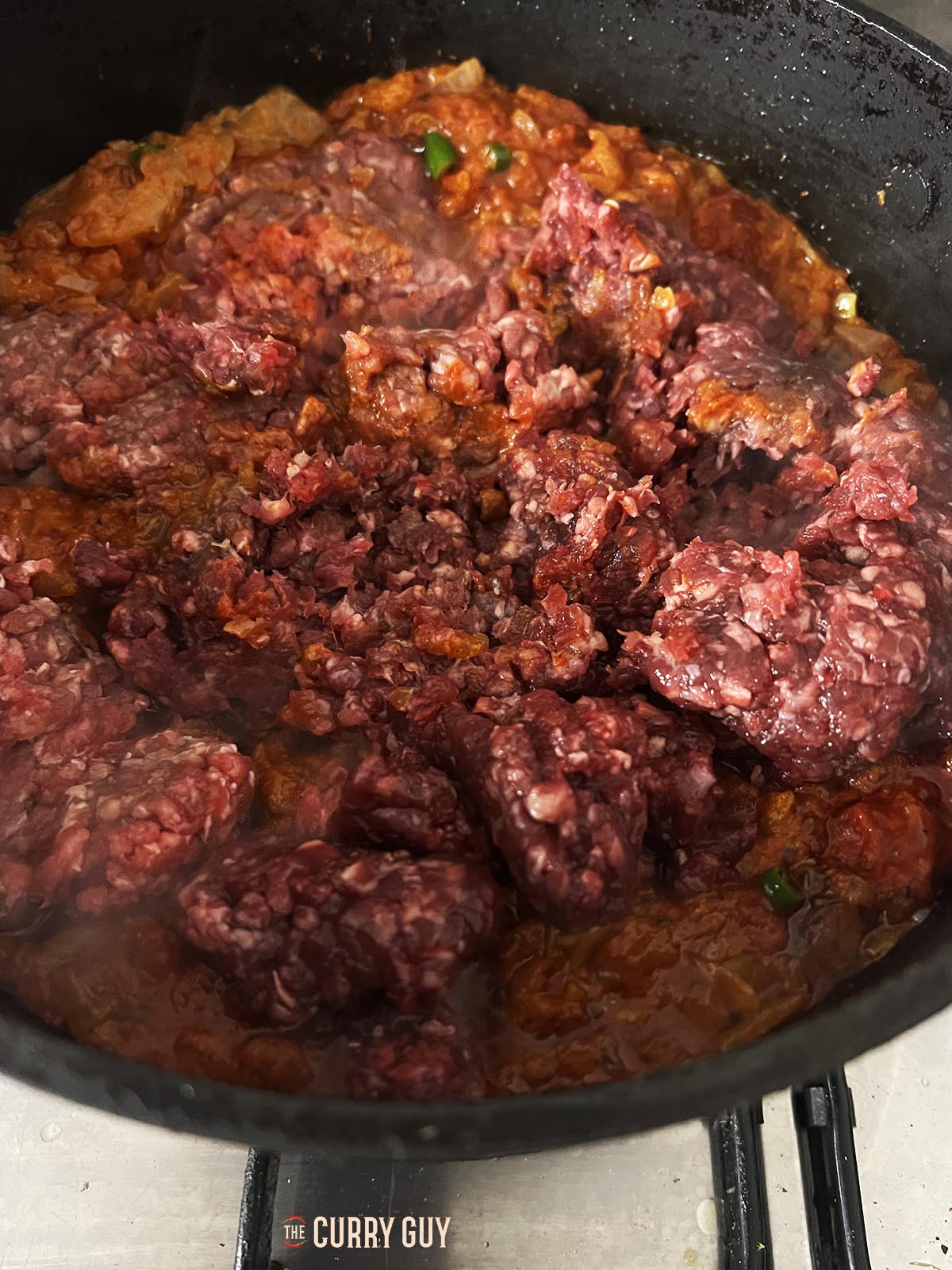 Adding the meat to the pan.