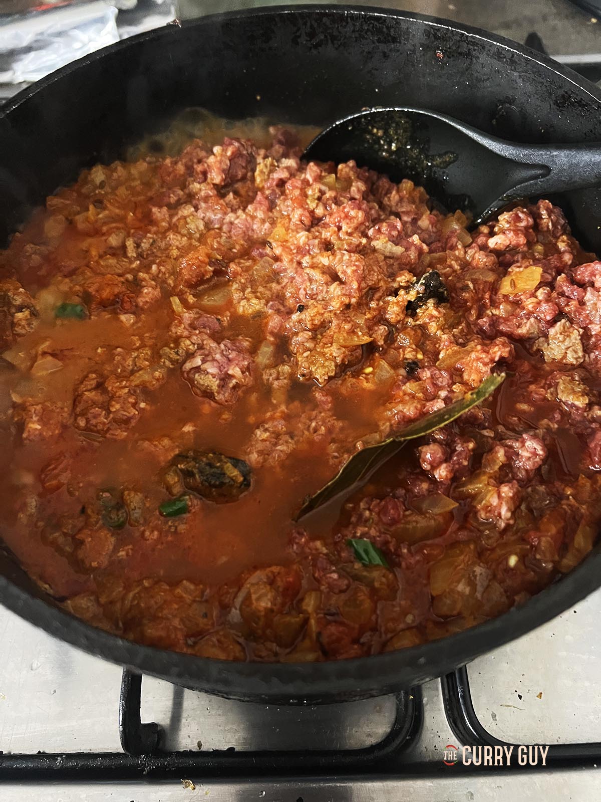 Adding water or stock to the pan.