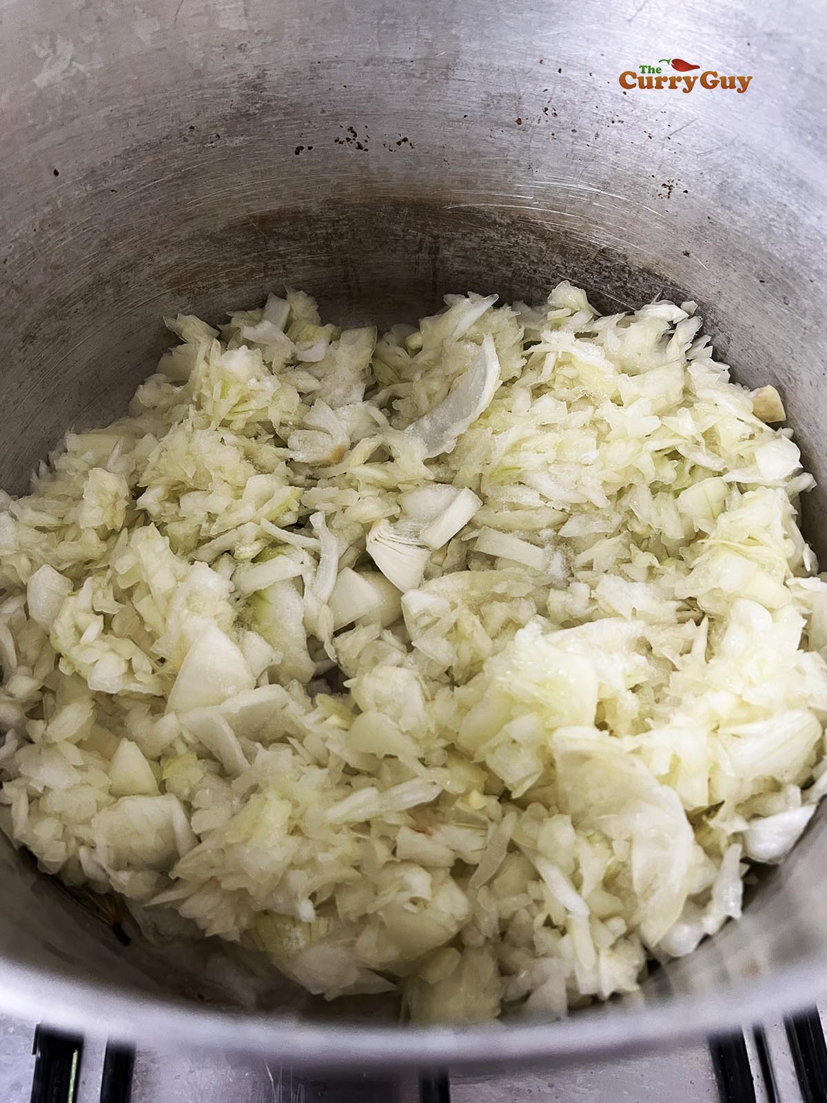 Adding the chopped onions to the pot.