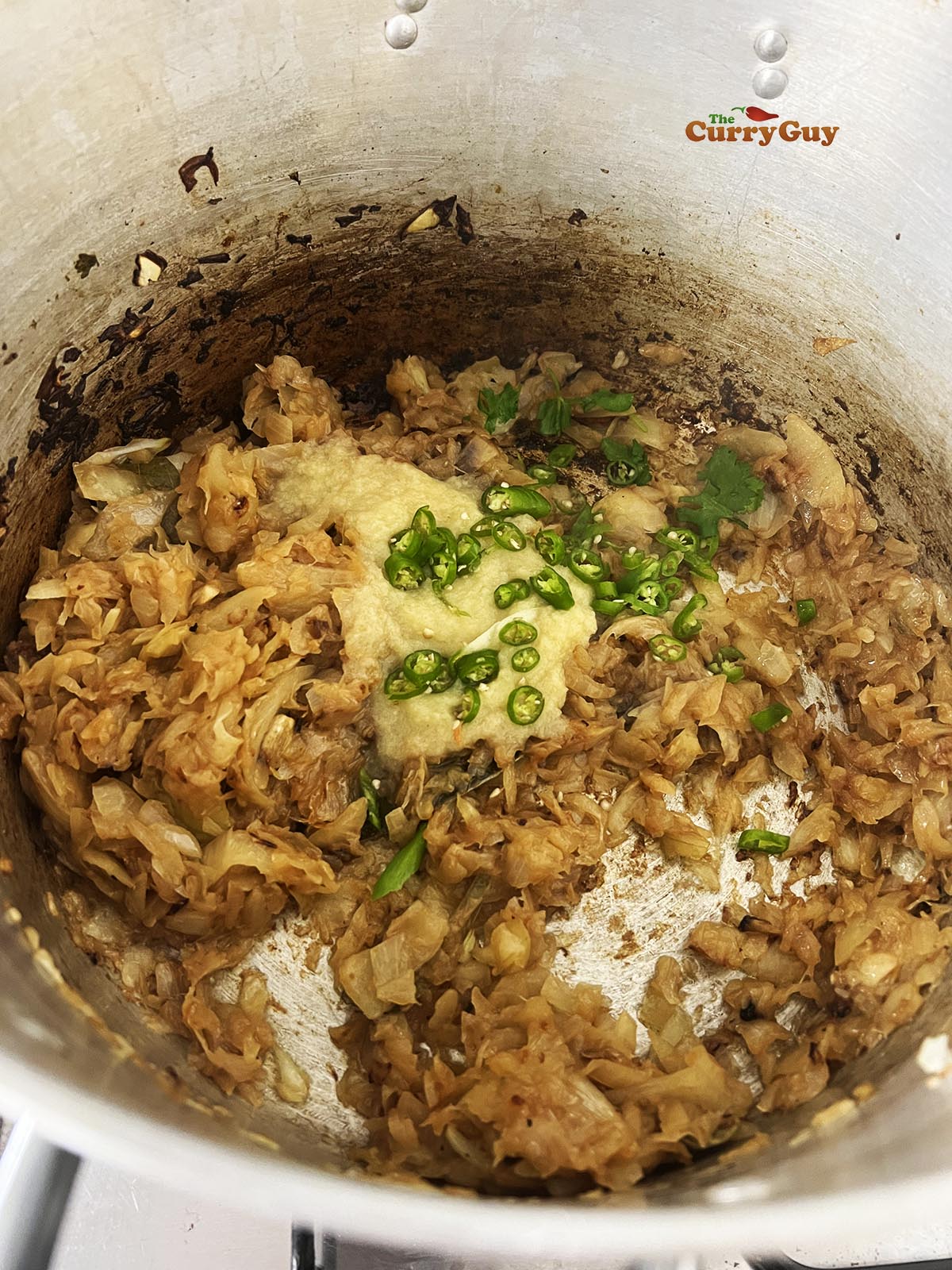 Adding garlic and ginger paste and the chillies to the pan.