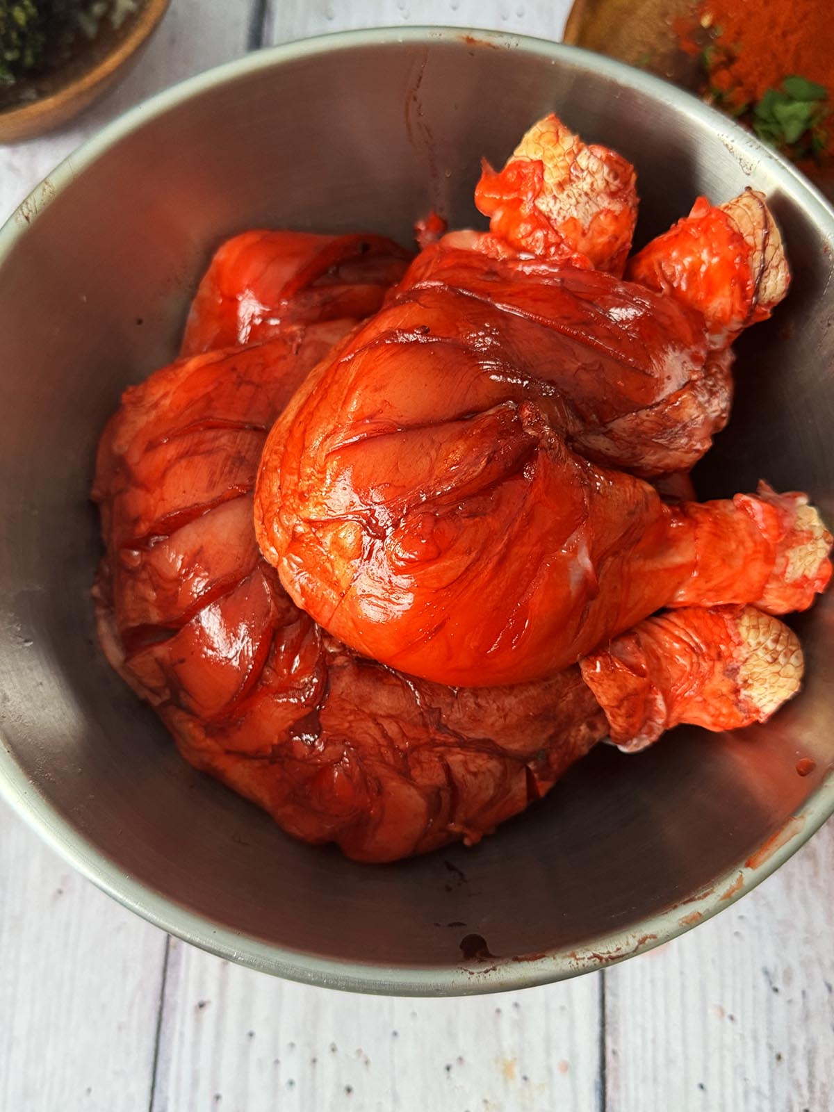 The chicken rubbed with lime juice and red food colouring powder. 