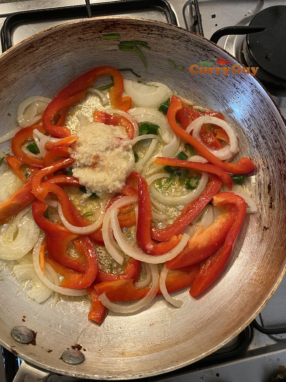 Adding garlic and ginger paste to the pan