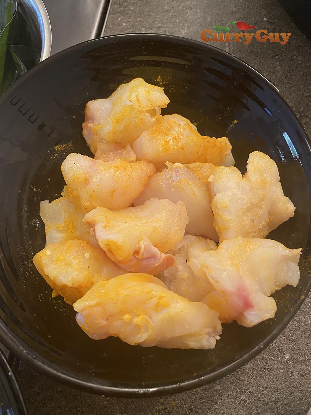 Monkfish marinating in turmeric