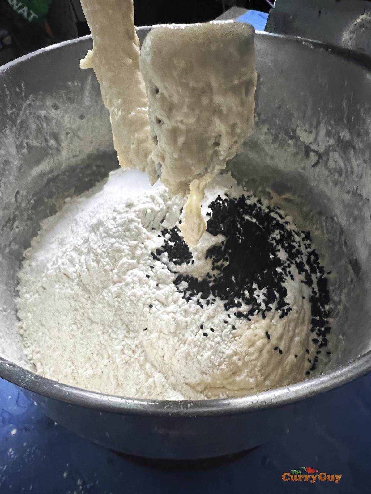 Adding the remaining flour to the bowl.