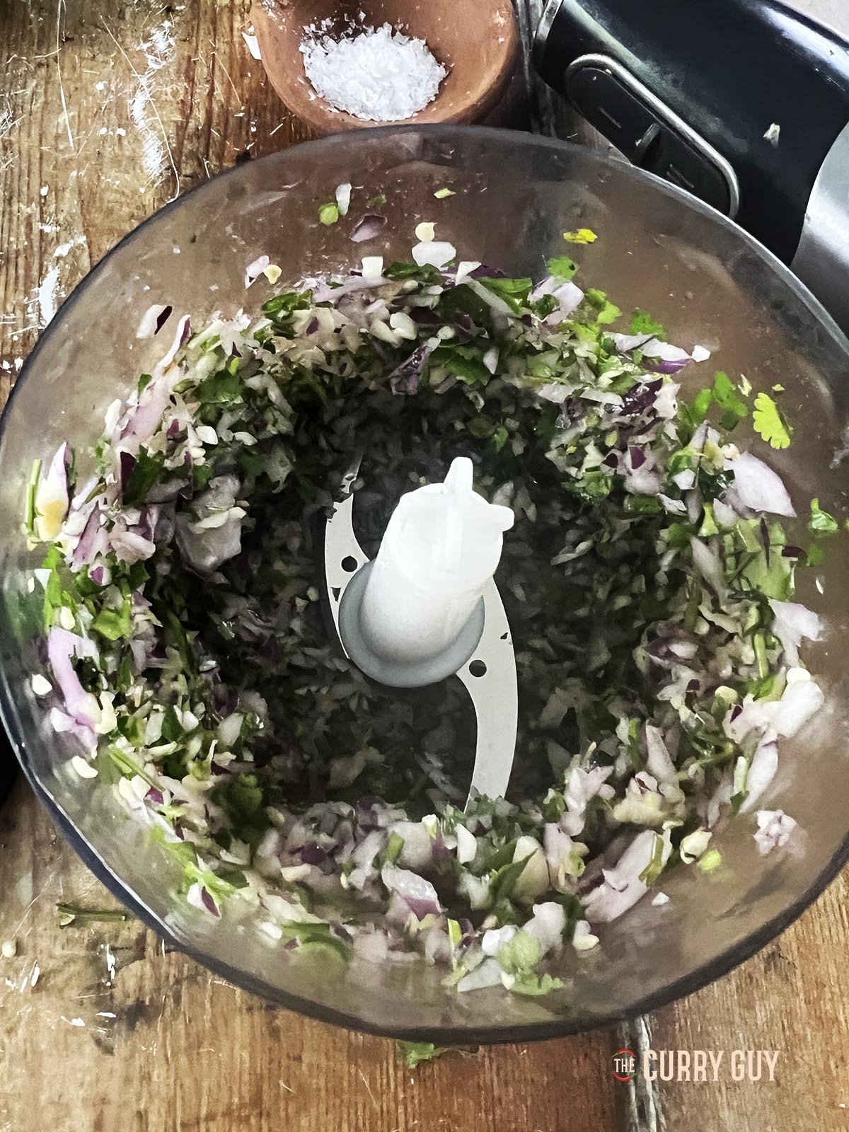 Finely chopped onions, chillies, garlic and coriander in a food processor.