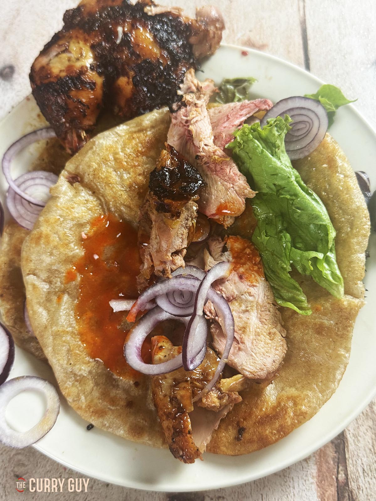 The roast pheasant on a paratha wrap with salad vegetables and hot sauce.