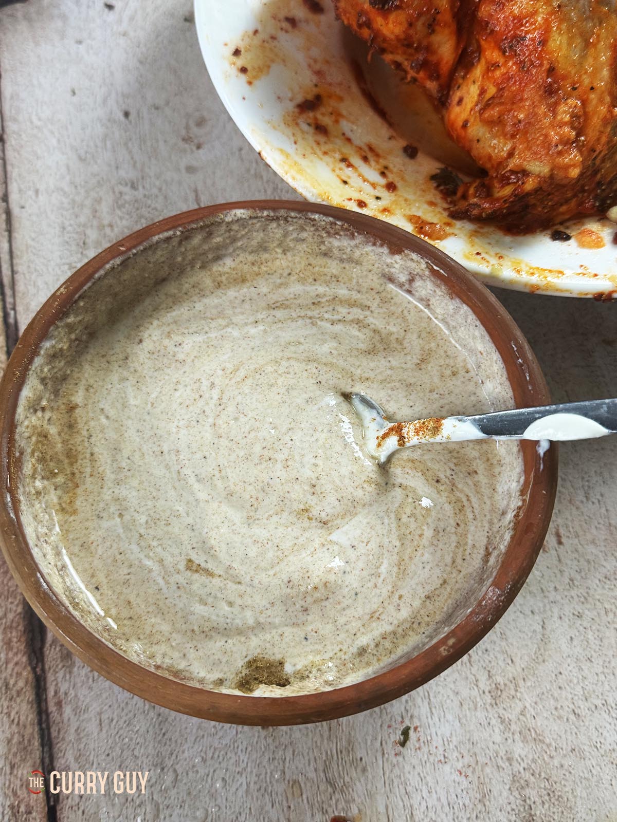 Whisking garlic and ginger paste, yoghurt and salt together until smooth.