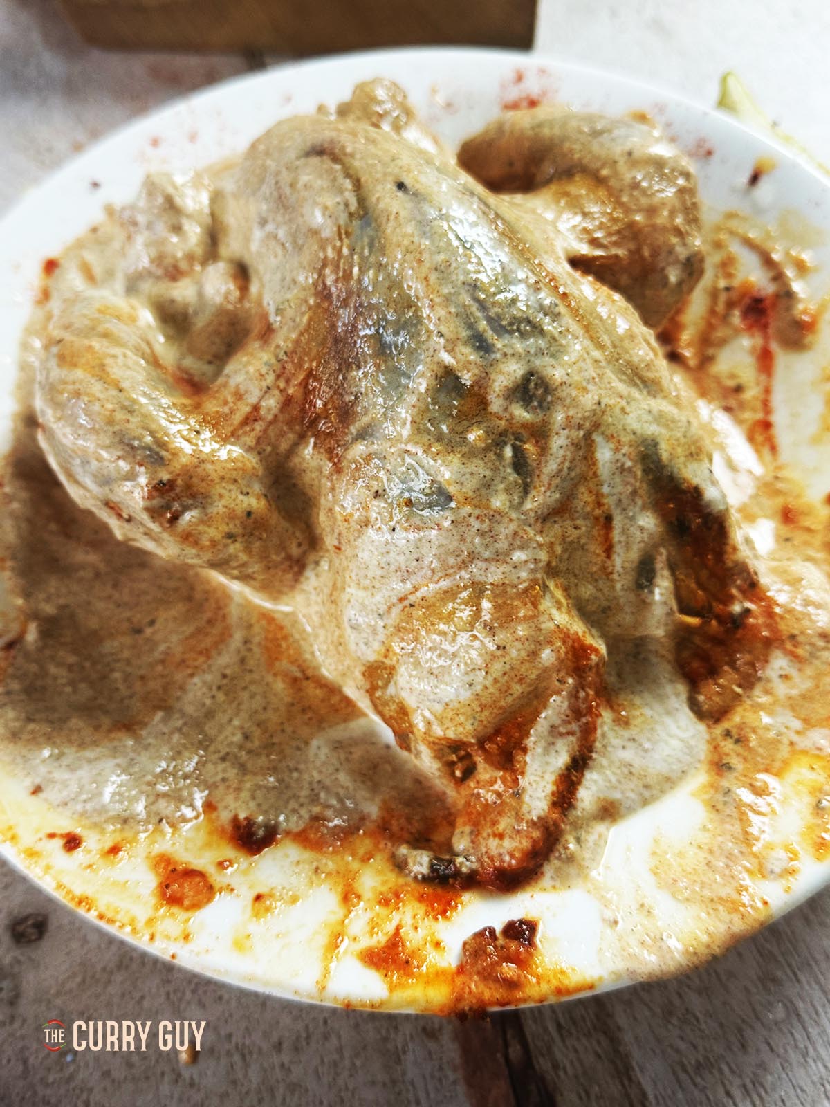 Applying the marinade to the pheasant.