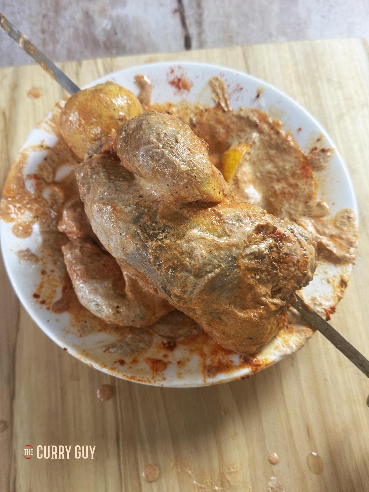 Skewering the pheasant for cooking. 