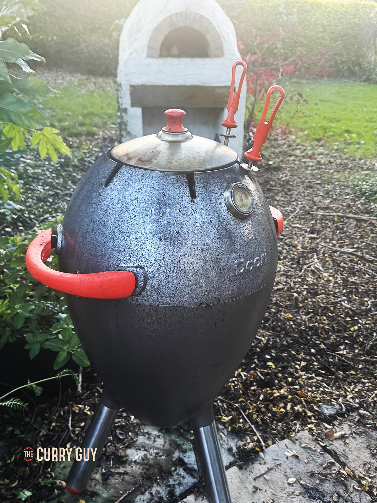 Cooking the pheasant in a covered tandoor oven.