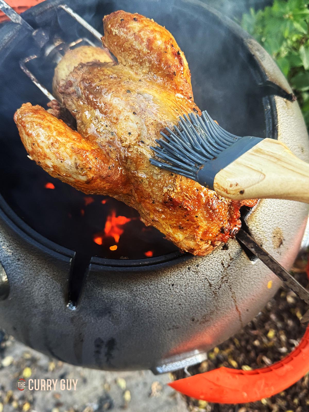 Basting the pheasant with the ghee and honey mixture.