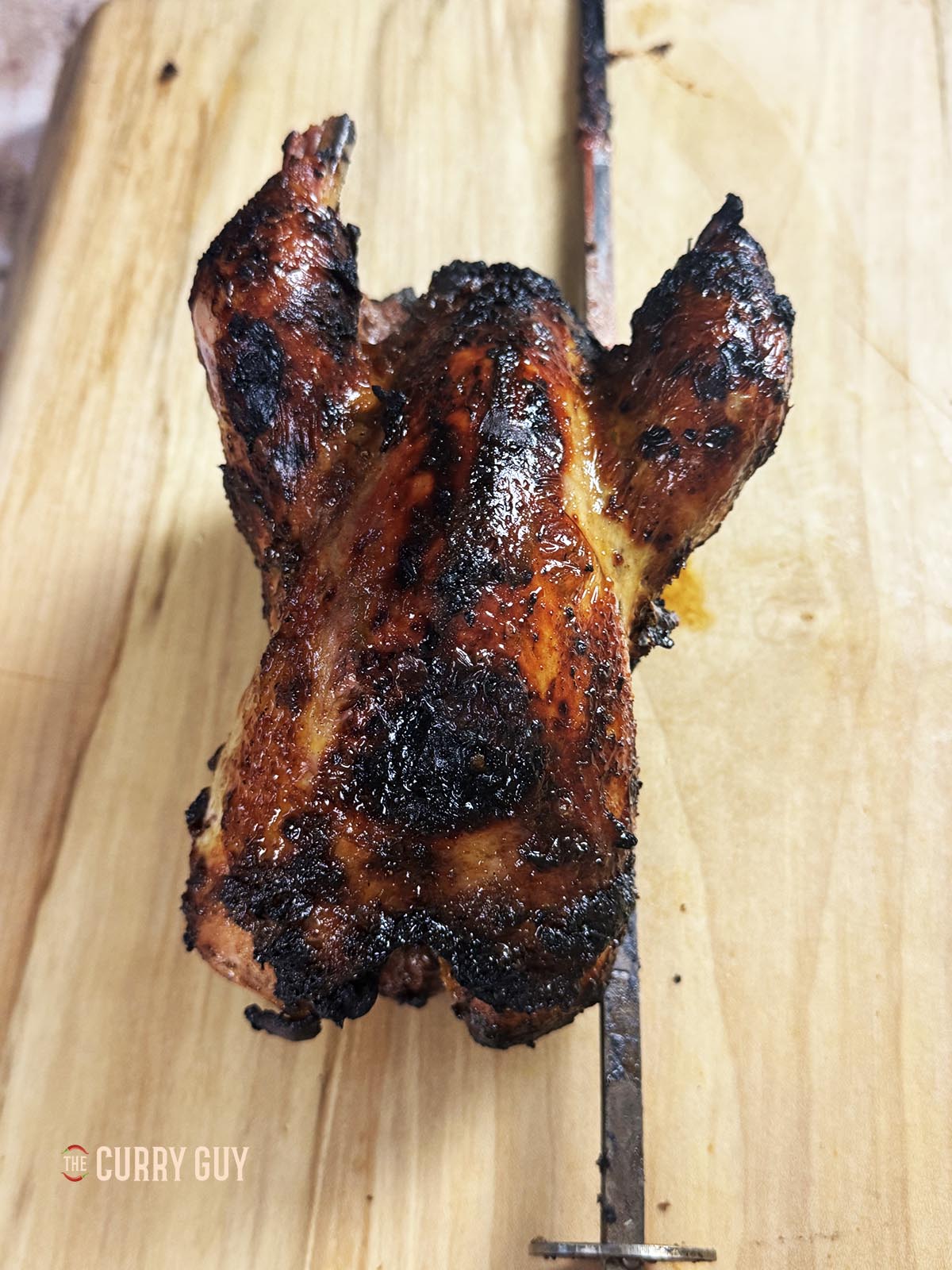 The roast pheasant on a cutting board, resting after the cook. 