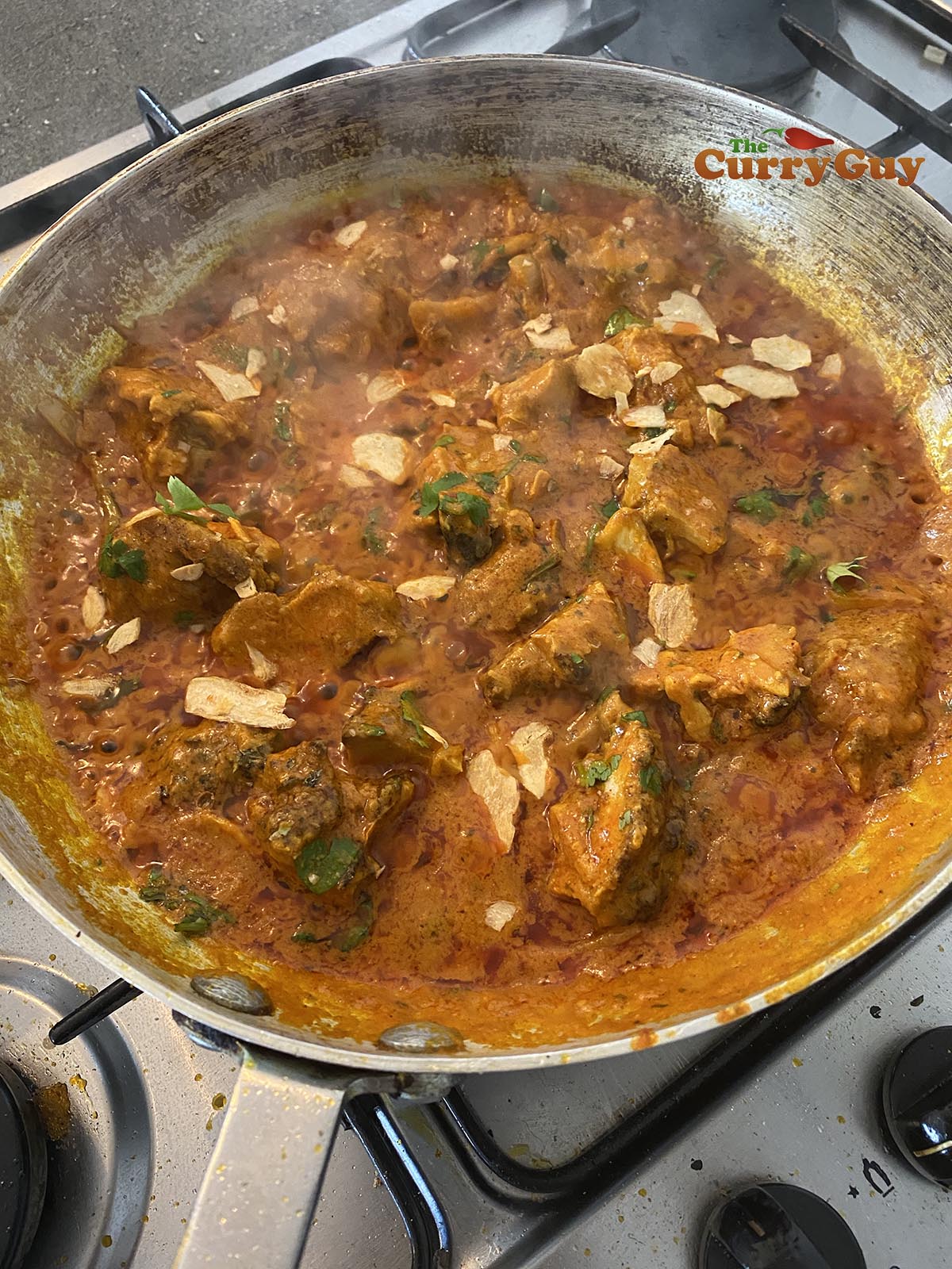Stirring in dried garlic and coriander (cilantro)