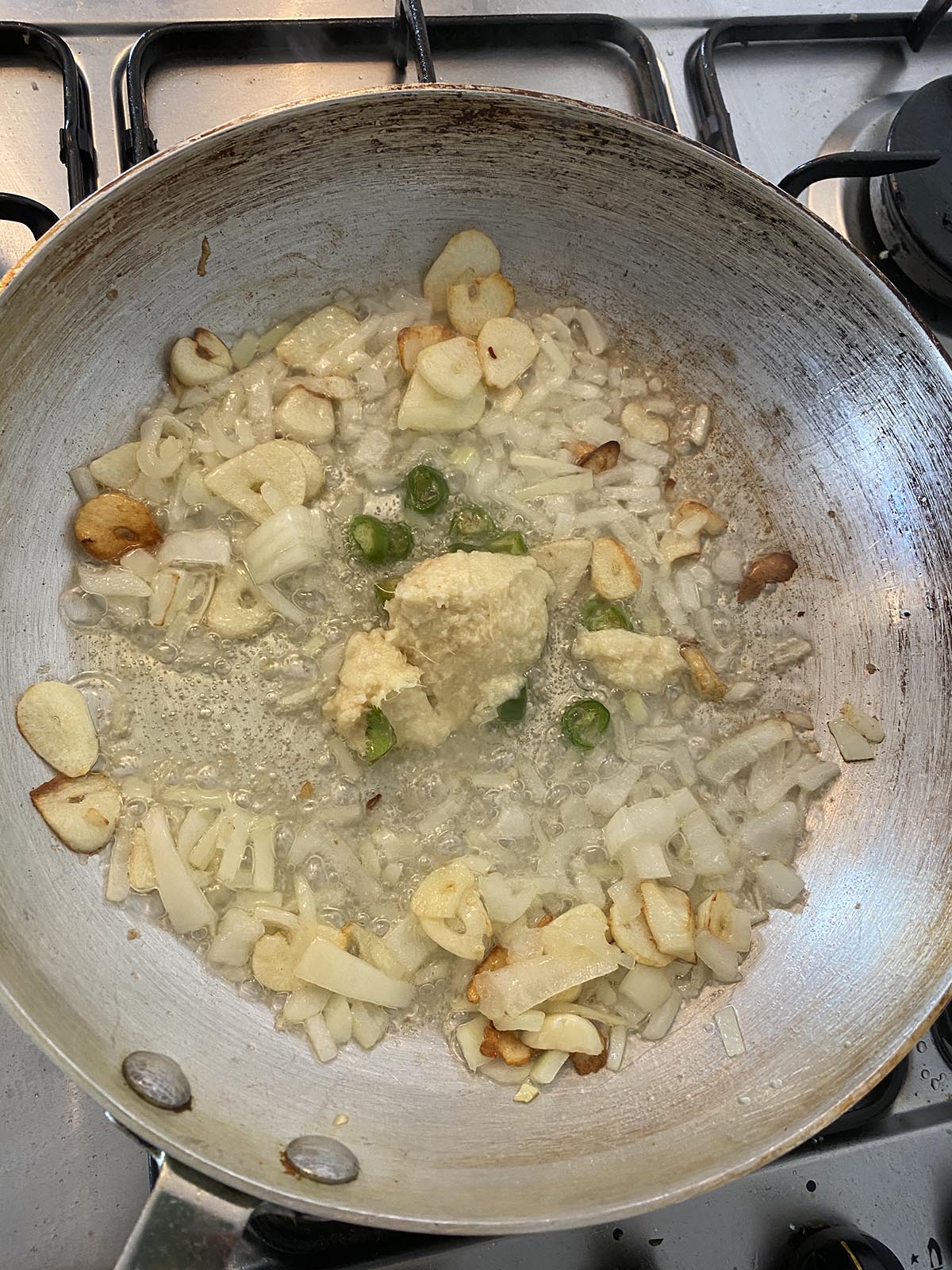Adding chillies and garlic/ginger paste to the pan