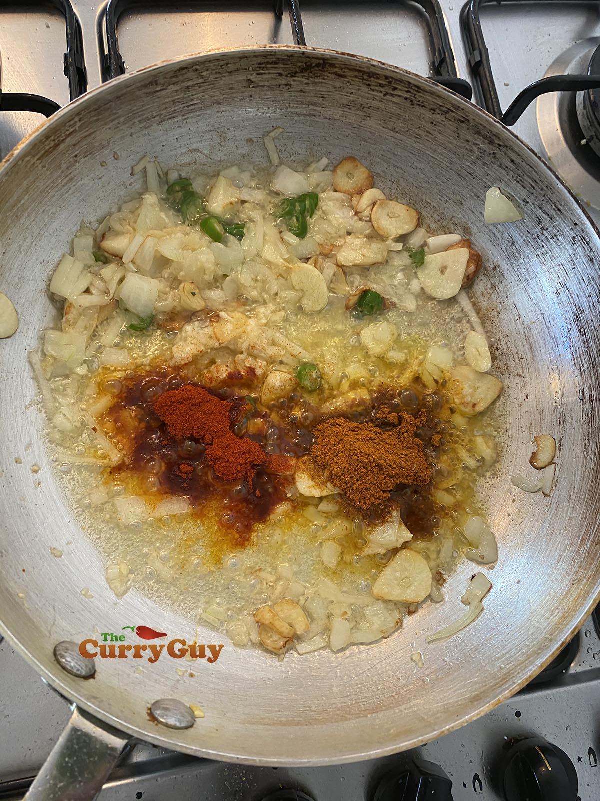 Adding chilli powder and mixed powder to the pan