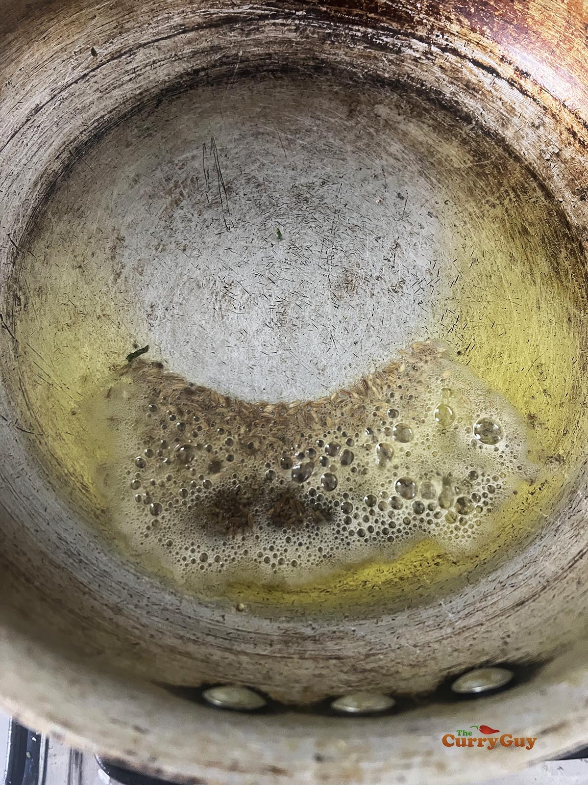 Infusing the flavour of cumin seeds into hot oil.