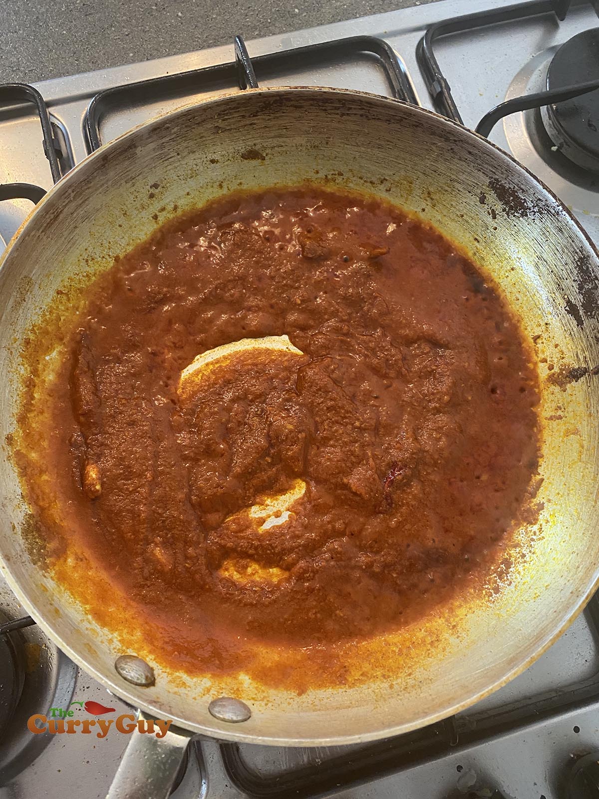 Pouring tomato puree into the pan