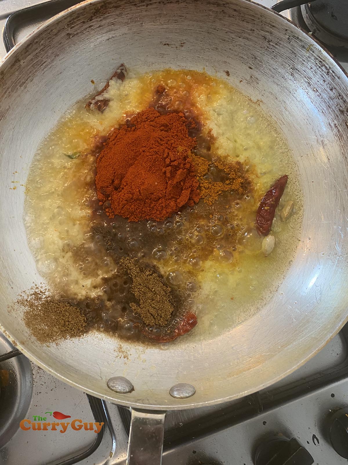 Adding ground spices to the pan