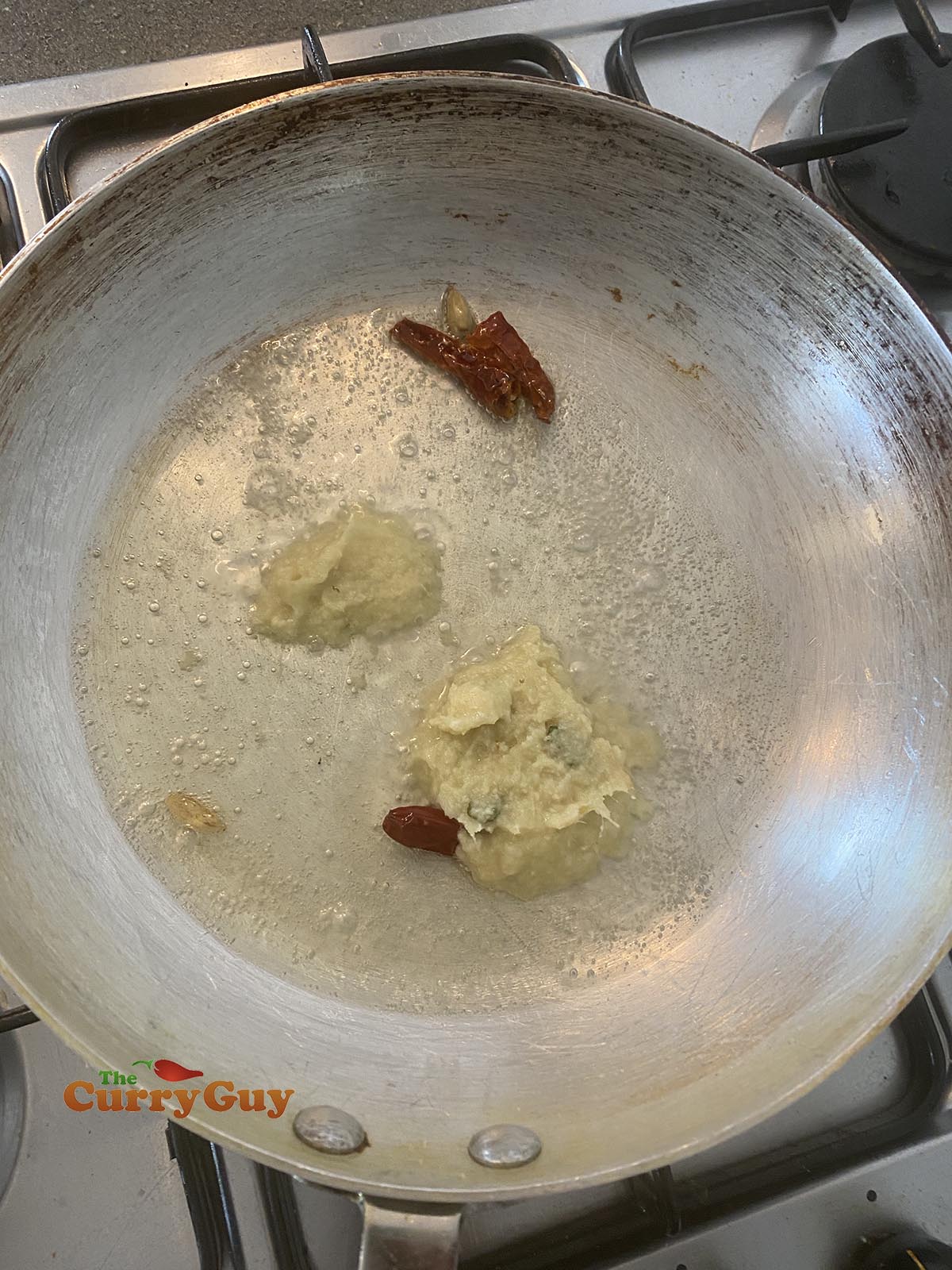 Adding garlic and ginger paste to the pan