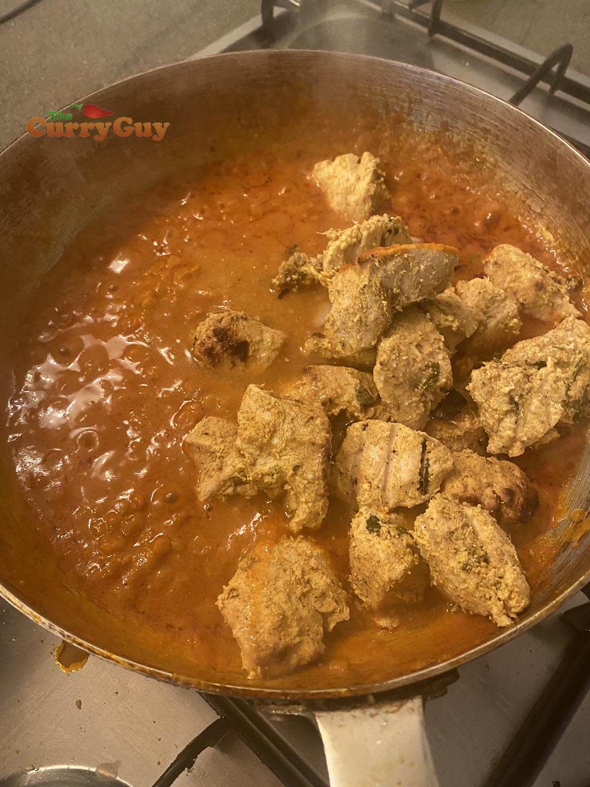 adding chicken to pan