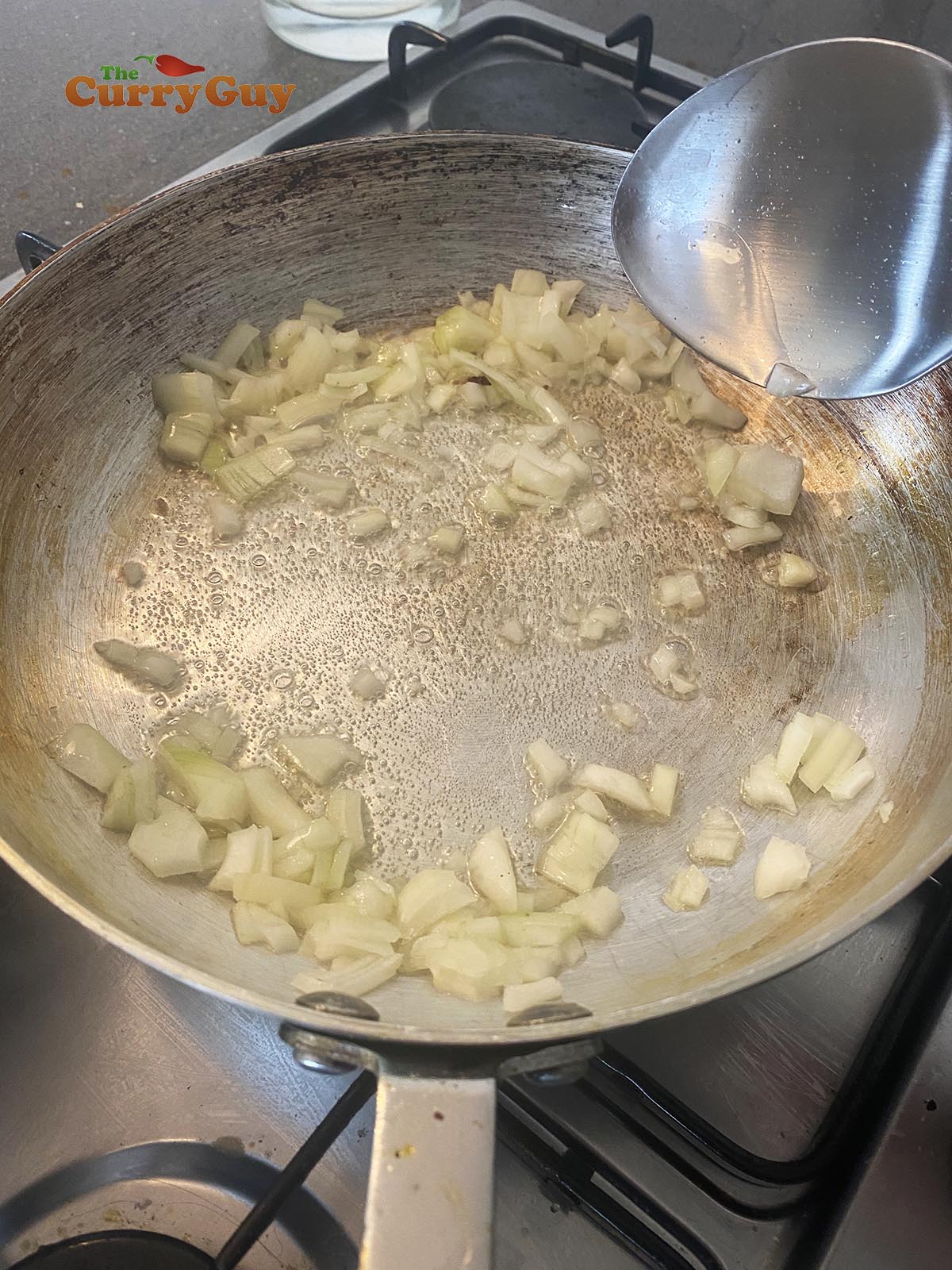 Frying onions in oil in a hot pan.
