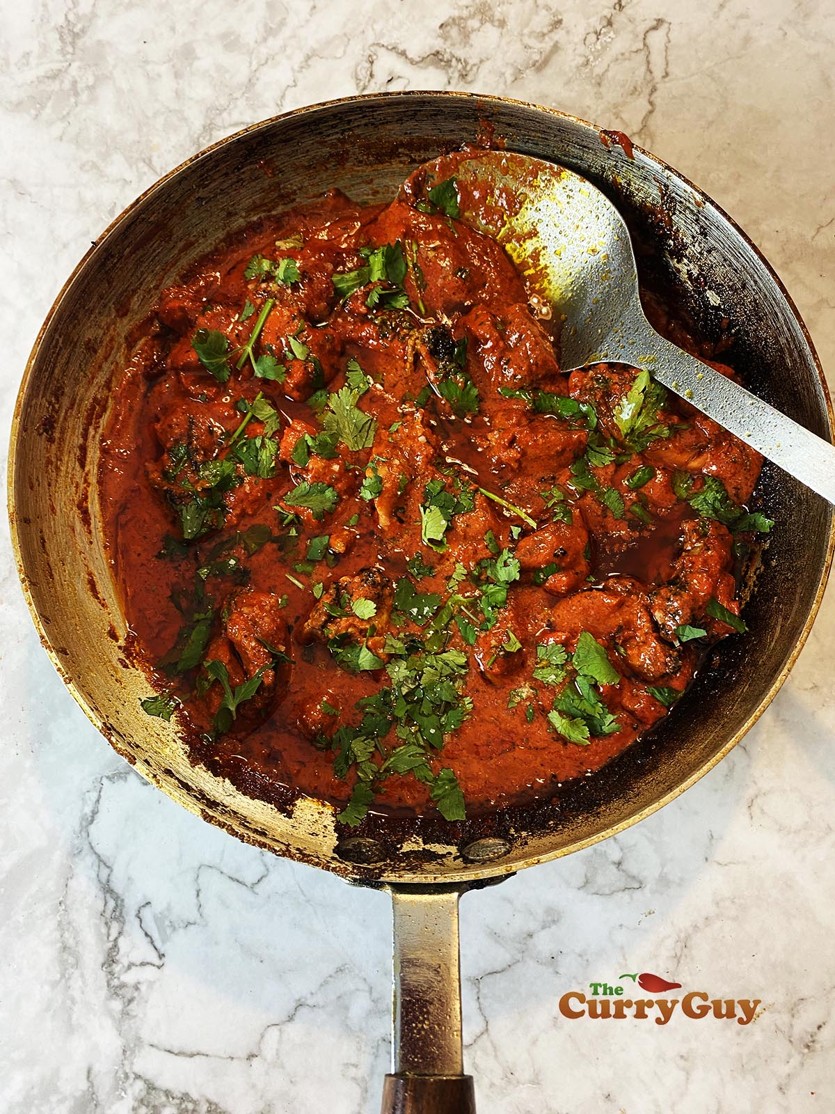 Chicken Tikka Masala Curry in a frying pan ready to serve.
