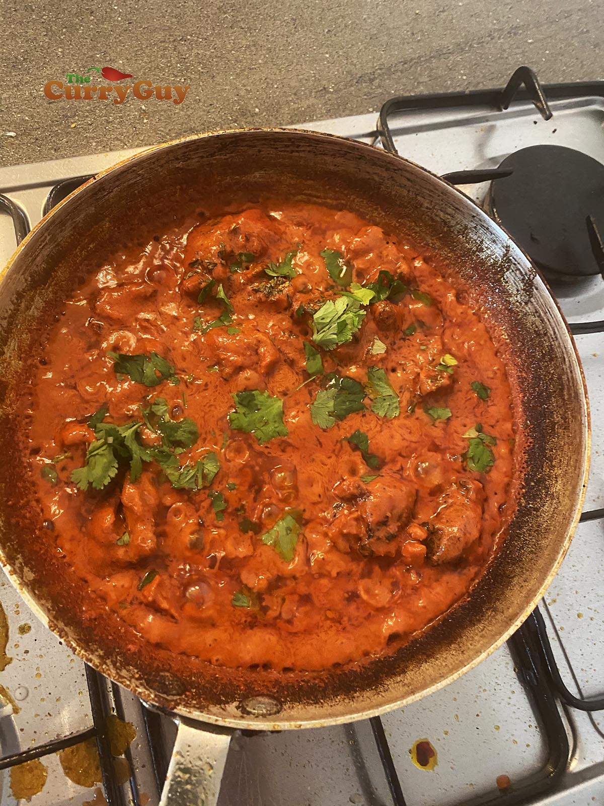 adding chopped coriander (cilantro) to the pan