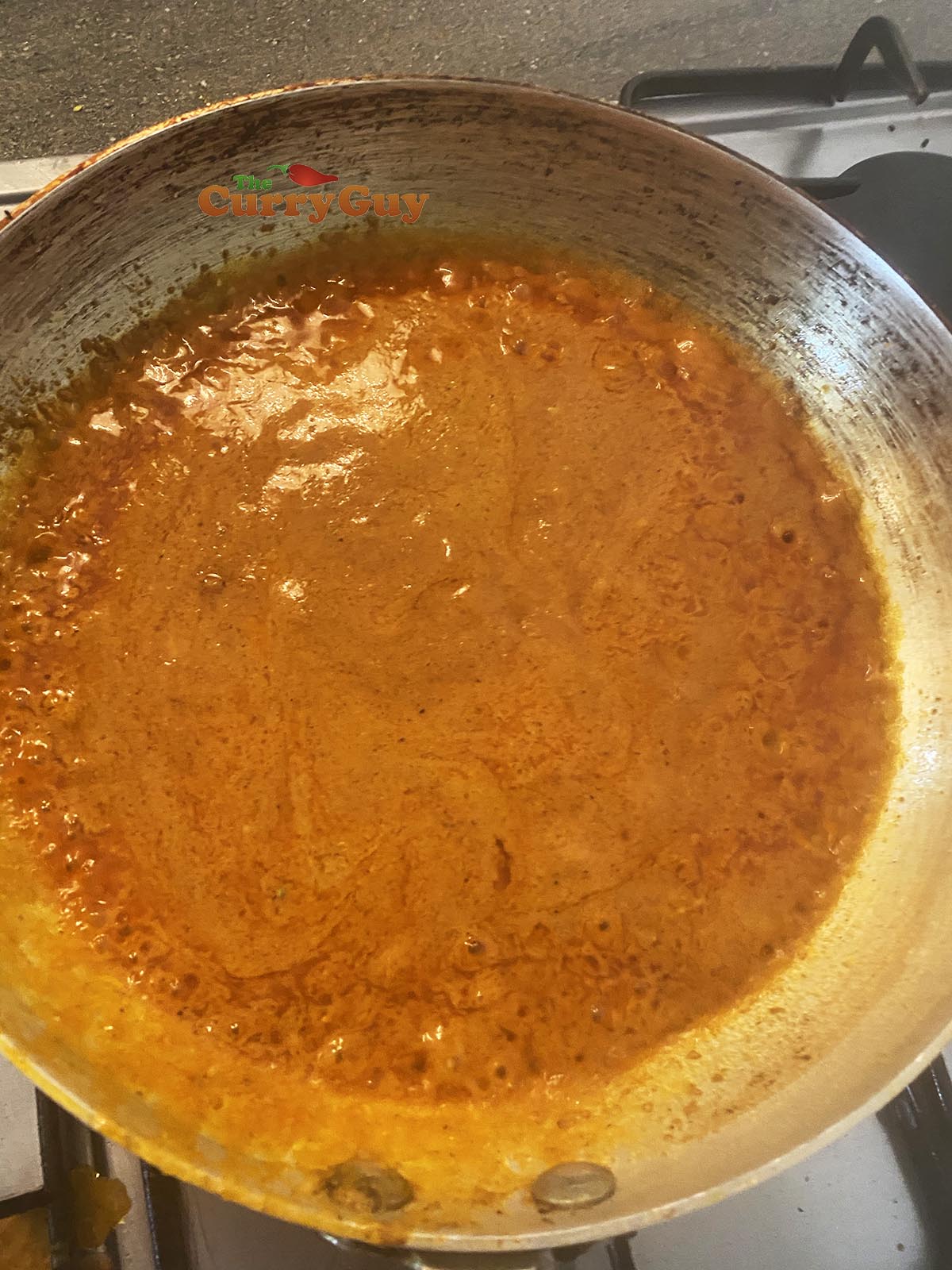 Adding base sauce to the pan