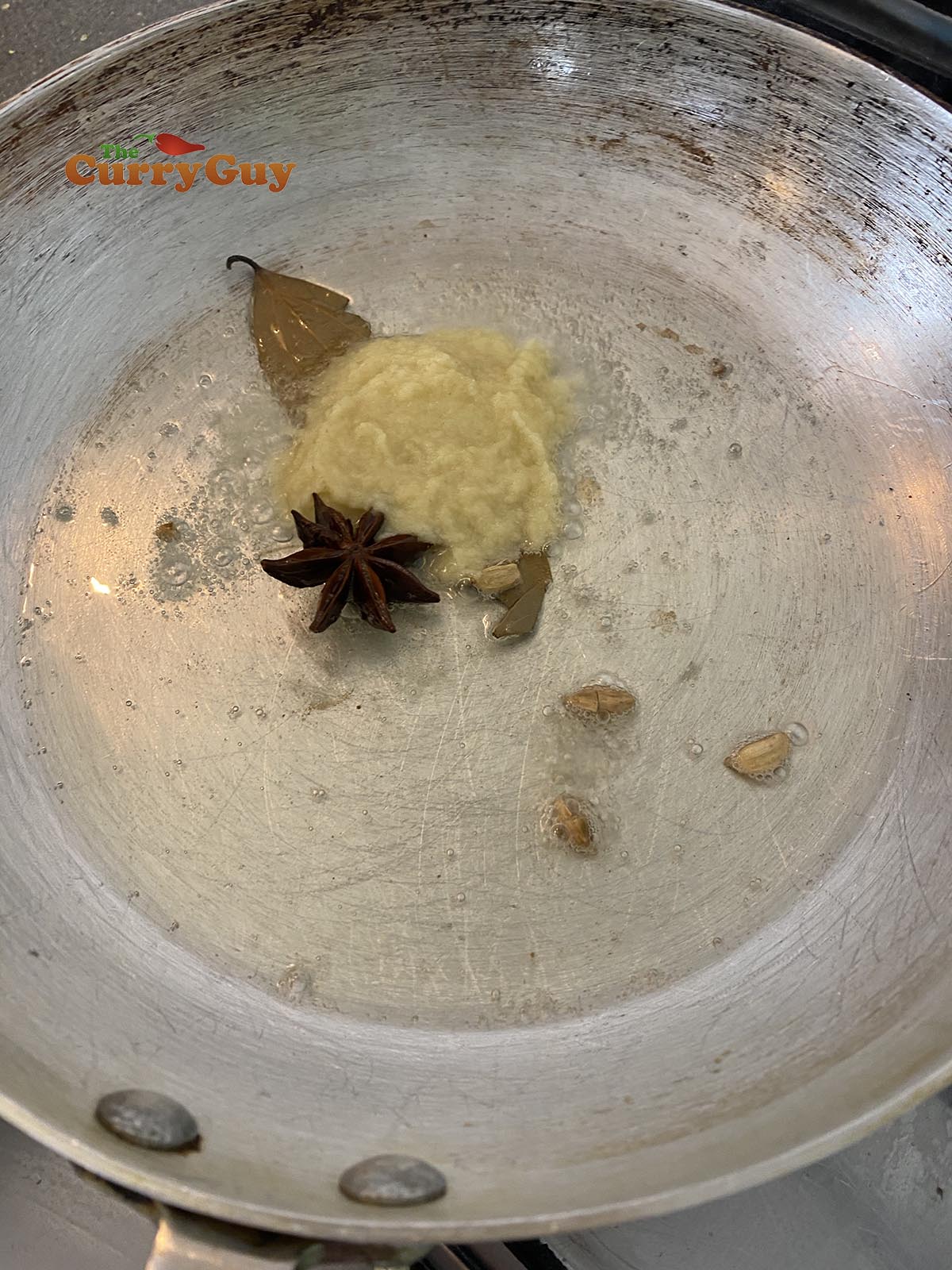 Adding garlic and ginger paste to the pan