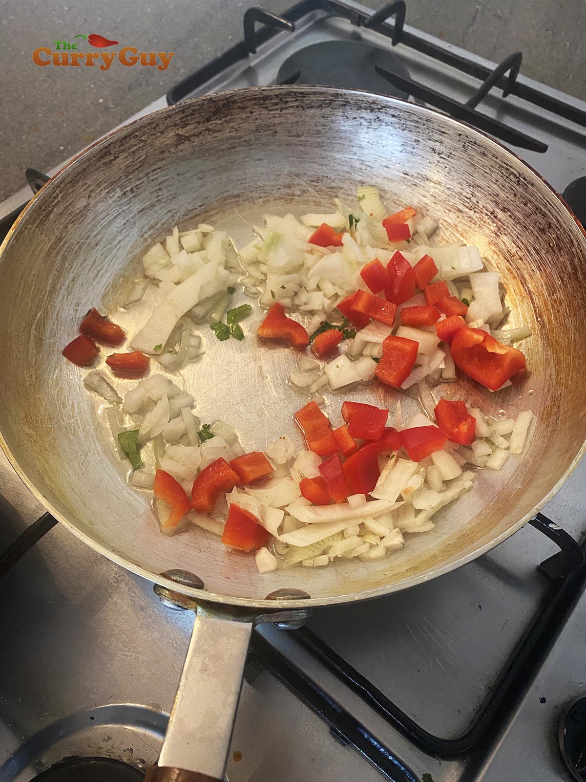 Frying onions, peppers and chillies