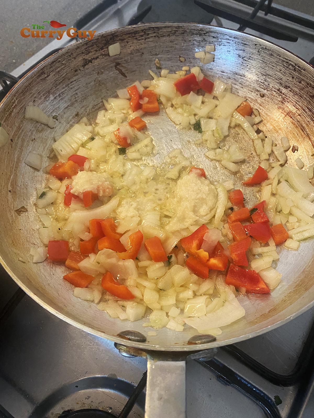 Adding garlic and ginger paste to the pan