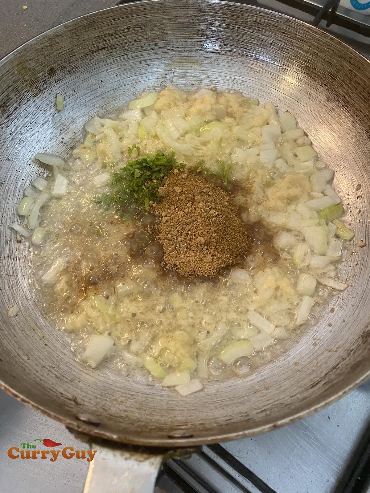 Adding ground spices to the pan