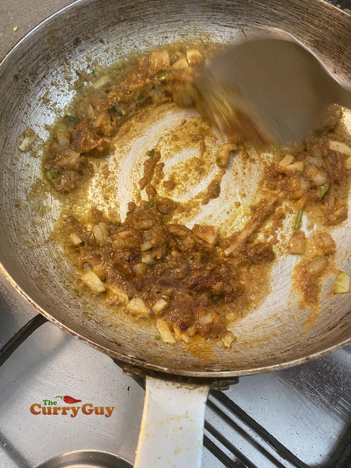 Stirring the sauce in the pan.