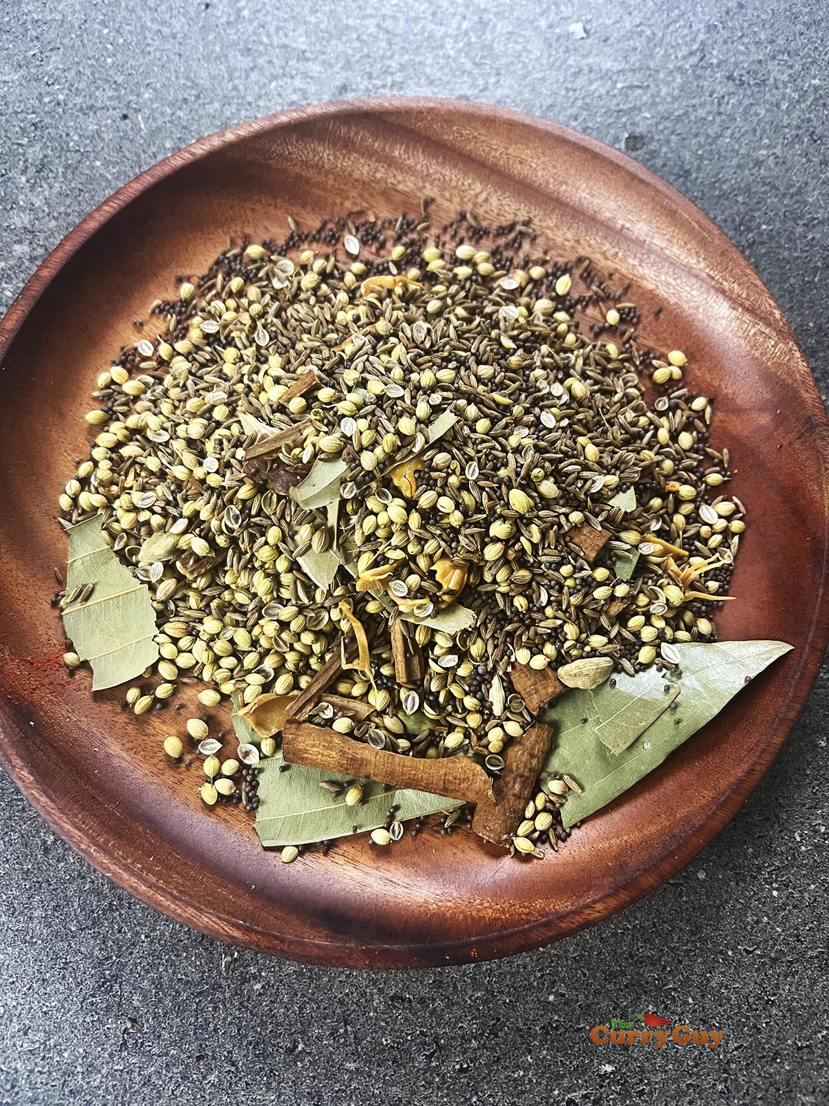 The roasted spices on a plate cooling.