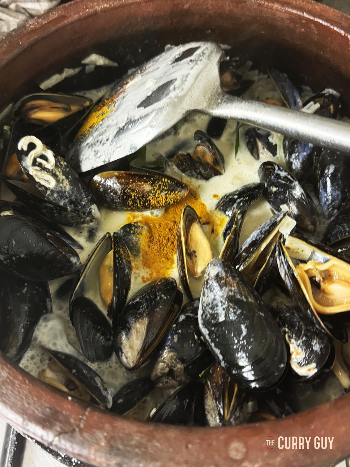 Adding the turmeric and saffron to the sauce.