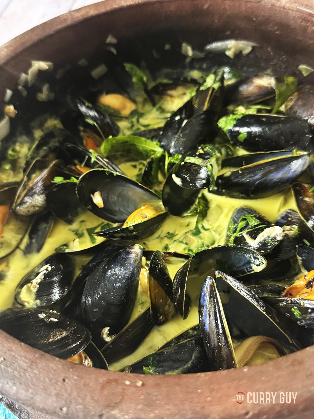 coconut curry mussels in a pot, ready to serve.