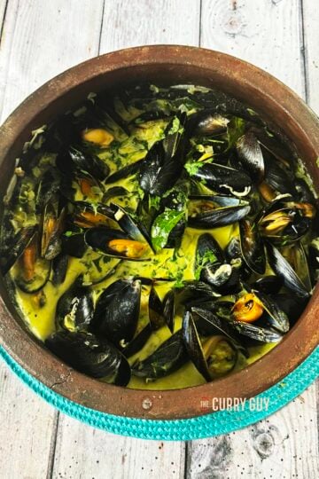 coconut curry mussels in the clay pot they were cooked in.