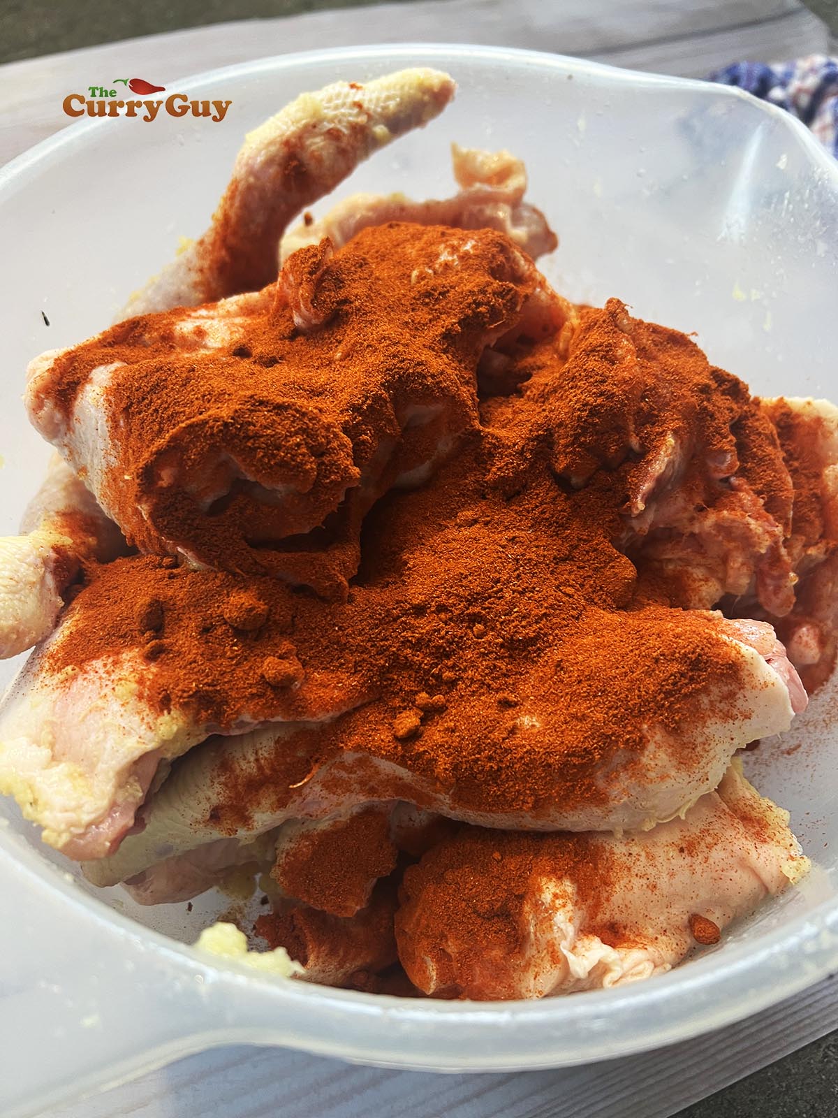 Adding chili powder to the chicken